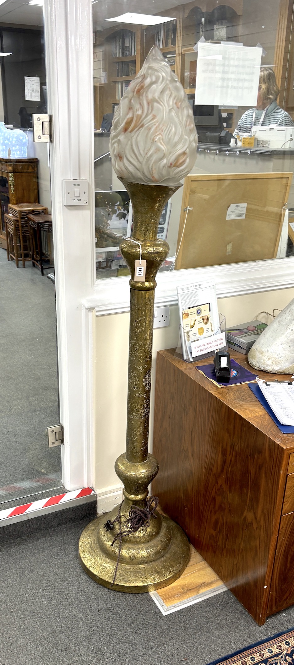 An early 20th century Indian brass floor lamp with associated opaque glass flambé shade, height 184cm